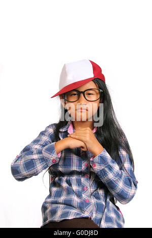Tough angry little girl with glasses and hat punching her fist into her palm isolated on white Stock Photo