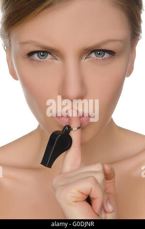 young woman holding finger and whistle before lips Stock Photo