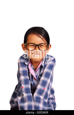 Cute Little girl with glasses performing tight lipped smile while closing her shoulders isolated on white Stock Photo