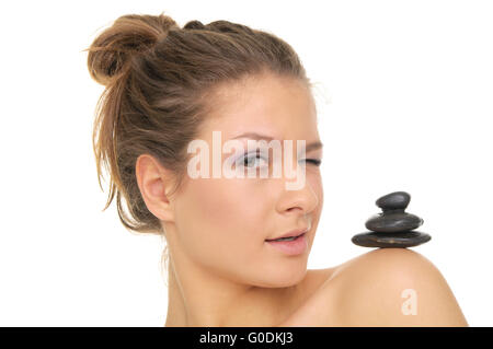 woman holding pile of stones on the shoulder Stock Photo