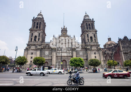 MEXICO CITY, MEXICO --A view of the front of the Metropolitan Cathedral from Madero Street which runs along the northern side of the Zocalo in the historic quarter of Mexico City. Built in stages from 1573 to 1813, the Mexico City Metropolitan Cathedral is the largest Roman Catholic cathedral in the Americas. It sits in the heart of the historic quarter of Mexico City along one side of the the Zocalo. Stock Photo