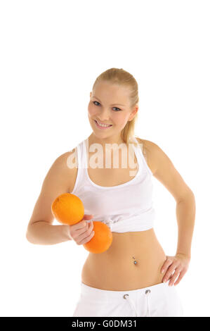 woman engaged in fitness dumbbells of oranges Stock Photo