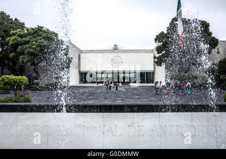 MEXICO CITY, Mexico — The main entrance and iconic fountain of the National Museum of Anthropology (Museo Nacional de Antropología). The museum, designed by architect Pedro Ramírez Vázquez, opened in 1964 in Chapultepec Park. The entrance features the distinctive 'El Paraguas' (The Umbrella) concrete fountain-column that serves as the museum's architectural centerpiece. Stock Photo