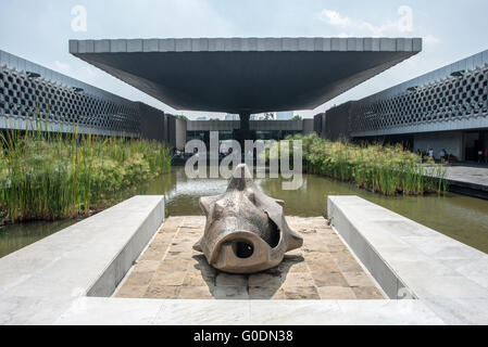 MEXICO CITY, Mexico — The iconic concrete umbrella structure dominates the central courtyard of the National Museum of Anthropology, designed by architect Pedro Ramírez Vázquez in 1964. The dramatic architectural feature, supported by a single pillar, serves both as a sculptural focal point and a practical shelter. The innovative design exemplifies mid-century Mexican modernist architecture while providing a striking centerpiece for Mexico's premier archaeological museum. Stock Photo