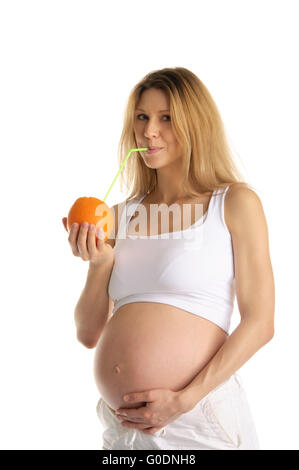 pregnant woman drinking juice from the orange Stock Photo