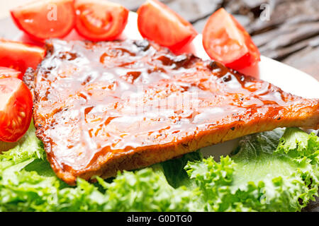 Delicious barbecued ribs seasoned with a spicy basting sauce Stock Photo