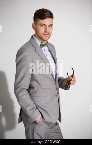 Attractive man in a suit and tie butterfly dress stylish sunglas Stock Photo