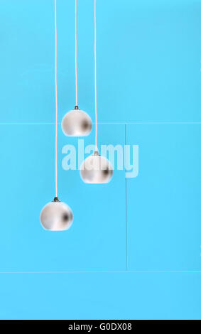 Blue negative collage of three ceiling lights, loft-style interior Stock Photo