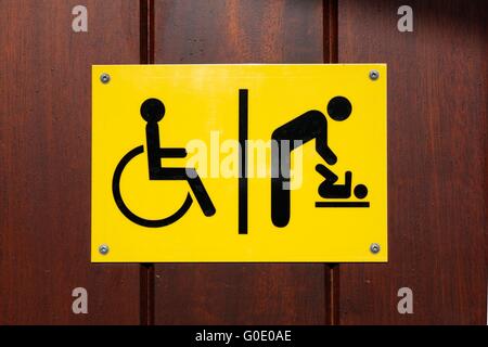 Yellow and black disabled and baby changing sign Stock Photo