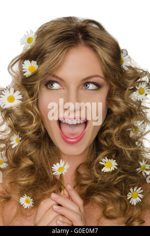 Smiling woman with daisies in hair looks away Stock Photo