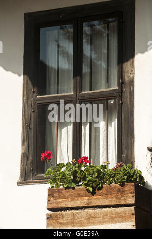 Wooden window of old white country-house facade Stock Photo