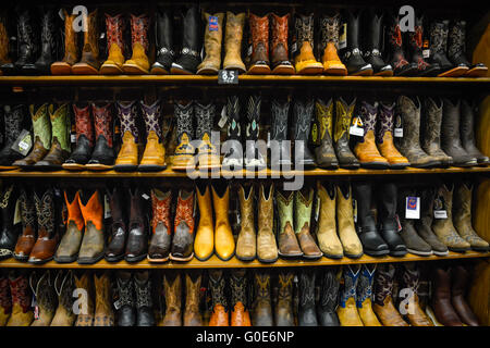 The Nashville Cowboy boot store has rows of unique Cowboy boots for sale in the downtown honky tonk district on Lower Broadway in Nashville, TN, USA Stock Photo