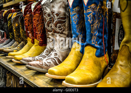 The Nashville Cowboy boot store has rows of unique Cowboy boots for sale in the downtown entertainment district in Nashville TN Stock Photo