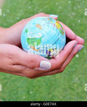 Woman holding globe on her hands Stock Photo