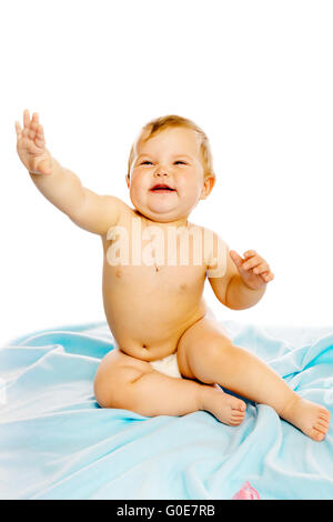 baby in diaper sitting on a blue blanket. Isolated Stock Photo