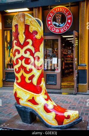 A huge fake yellow & red promo cowboy boot, artistically rendered in resin fronts The Nashville Cowboy boot store, Nashville TN Stock Photo