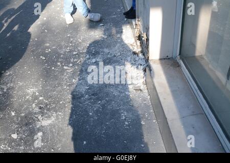 Paris, France. 1 May 2016. Walls smashed for protesters to throw bricks at police. Credit: Marc Ward/Alamy Live News Stock Photo