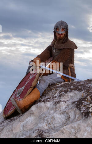 Knight sitting on a rock Stock Photo