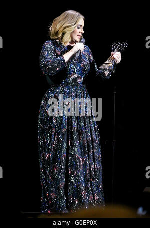 Adele wins an award whilst on stage in Birmingham as she wraps her UK tour. Adele was presented the iHeartRadio music awards gong for best song and gave an acceptance speech mid concert at the Genting Arena in Birmingham as she wraps her UK Tour this week.  Featuring: Adele Adkins Where: Birmingham, United Kingdom When: 30 Mar 2016 Stock Photo