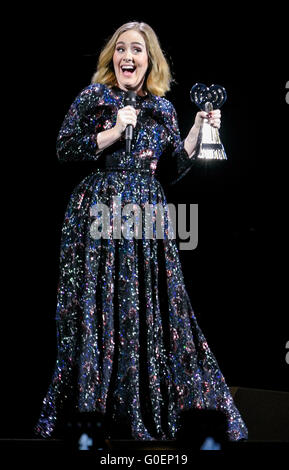 Adele wins an award whilst on stage in Birmingham as she wraps her UK tour. Adele was presented the iHeartRadio music awards gong for best song and gave an acceptance speech mid concert at the Genting Arena in Birmingham as she wraps her UK Tour this week.  Featuring: Adele Adkins Where: Birmingham, United Kingdom When: 30 Mar 2016 Stock Photo