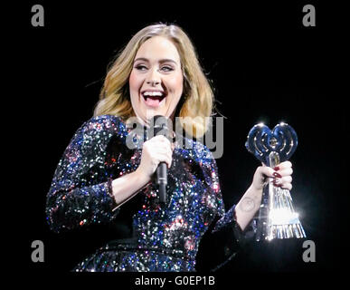 Adele wins an award whilst on stage in Birmingham as she wraps her UK tour. Adele was presented the iHeartRadio music awards gong for best song and gave an acceptance speech mid concert at the Genting Arena in Birmingham as she wraps her UK Tour this week.  Featuring: Adele Adkins Where: Birmingham, United Kingdom When: 30 Mar 2016 Stock Photo