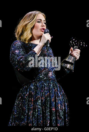 Adele wins an award whilst on stage in Birmingham as she wraps her UK tour. Adele was presented the iHeartRadio music awards gong for best song and gave an acceptance speech mid concert at the Genting Arena in Birmingham as she wraps her UK Tour this week.  Featuring: Adele Adkins Where: Birmingham, United Kingdom When: 30 Mar 2016 Stock Photo