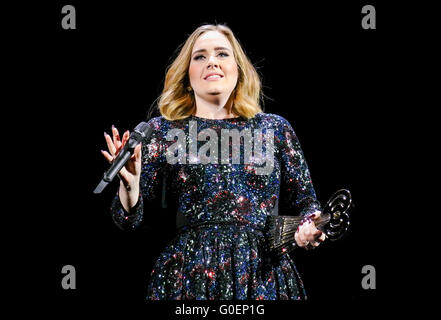 Adele wins an award whilst on stage in Birmingham as she wraps her UK tour. Adele was presented the iHeartRadio music awards gong for best song and gave an acceptance speech mid concert at the Genting Arena in Birmingham as she wraps her UK Tour this week.  Featuring: Adele Adkins Where: Birmingham, United Kingdom When: 30 Mar 2016 Stock Photo