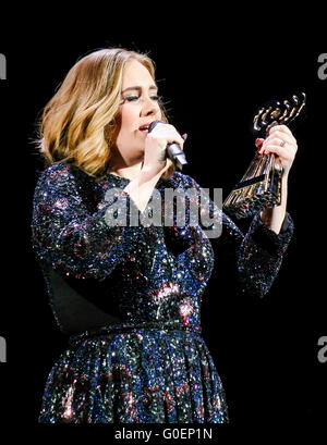 Adele wins an award whilst on stage in Birmingham as she wraps her UK tour. Adele was presented the iHeartRadio music awards gong for best song and gave an acceptance speech mid concert at the Genting Arena in Birmingham as she wraps her UK Tour this week.  Featuring: Adele Adkins Where: Birmingham, United Kingdom When: 30 Mar 2016 Stock Photo