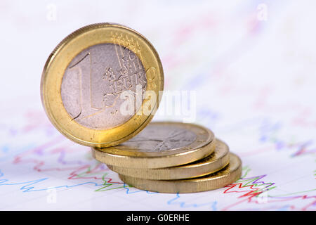 stacked Euro coins on chart of stock market Stock Photo