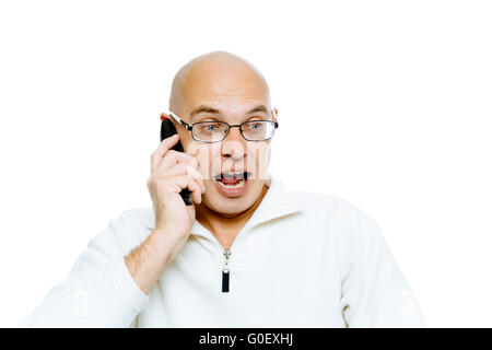 Bald man emotionally communicates by phone. Isolated. Studio Stock Photo