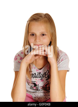A sad looking young girl sitting on chair. Stock Photo