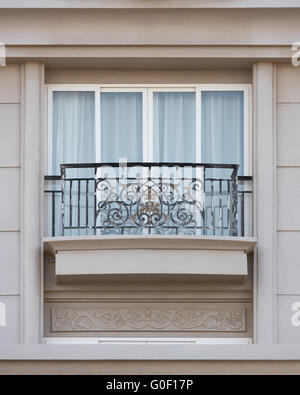 forged balcony in stone building Stock Photo