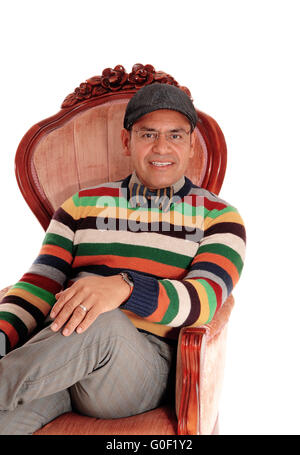 Happy middle age man sitting in armchair. Stock Photo