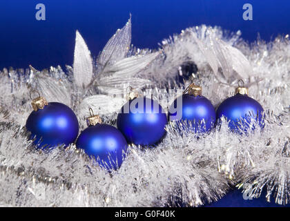 Blue New Year's balls and tinsel on a blue background Stock Photo