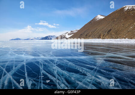 Winter ice landscape on Siberian lake Baikal with clouds Stock Photo