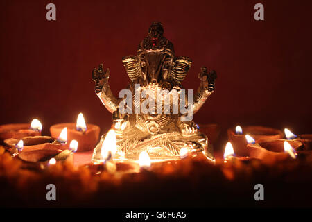 Ganesh idol surrounding with oil lamp, festival season Stock Photo