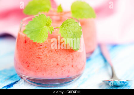 Smoothie drink with mint on table, in high key Stock Photo