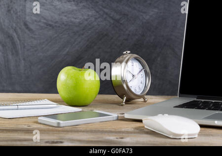 Old wooden desktop with technology and green apple Stock Photo