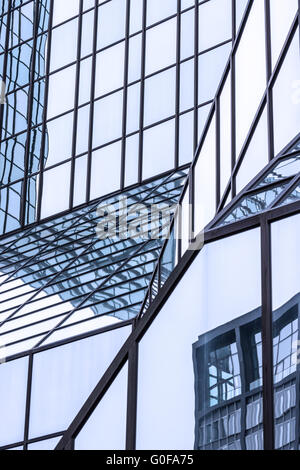 Reflecting glass facade of a highrise Stock Photo