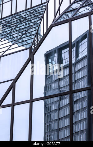 Reflecting glass facade of a highrise Stock Photo