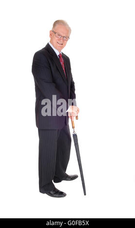 Middle age man in suit with umbrella. Stock Photo