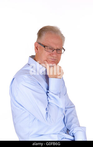 Mature man sitting and thinking. Stock Photo