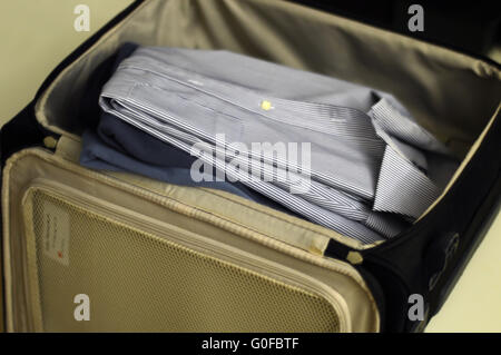 Packing the suitcase for a business trip Stock Photo