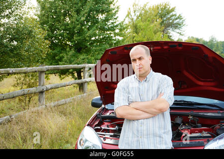 Adult man is standing near car Stock Photo