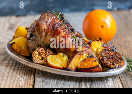 Thigh of turkey baked with rosemary and orange. Stock Photo