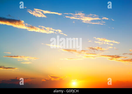 Sunset sky perfect background. Sun shining through clouds Stock Photo