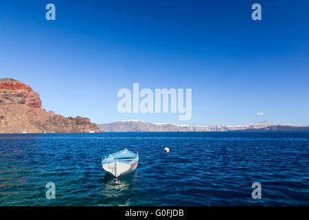Blue and white boat on the Aegean sea. Therasia island near Santorini Stock Photo