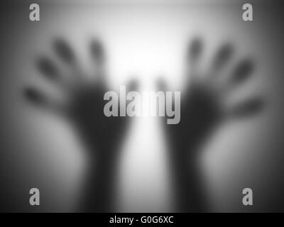 Hands silhouettes touching blurry glass screaming for help Stock Photo