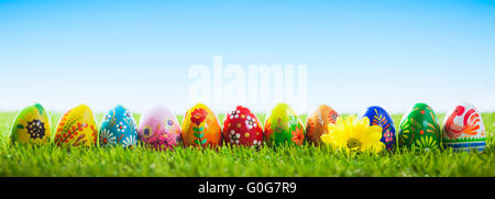 Colorful hand painted Easter eggs on grass. Banner, panoramic Stock Photo