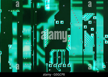 green electrical circuit board with conductors and transistors Stock